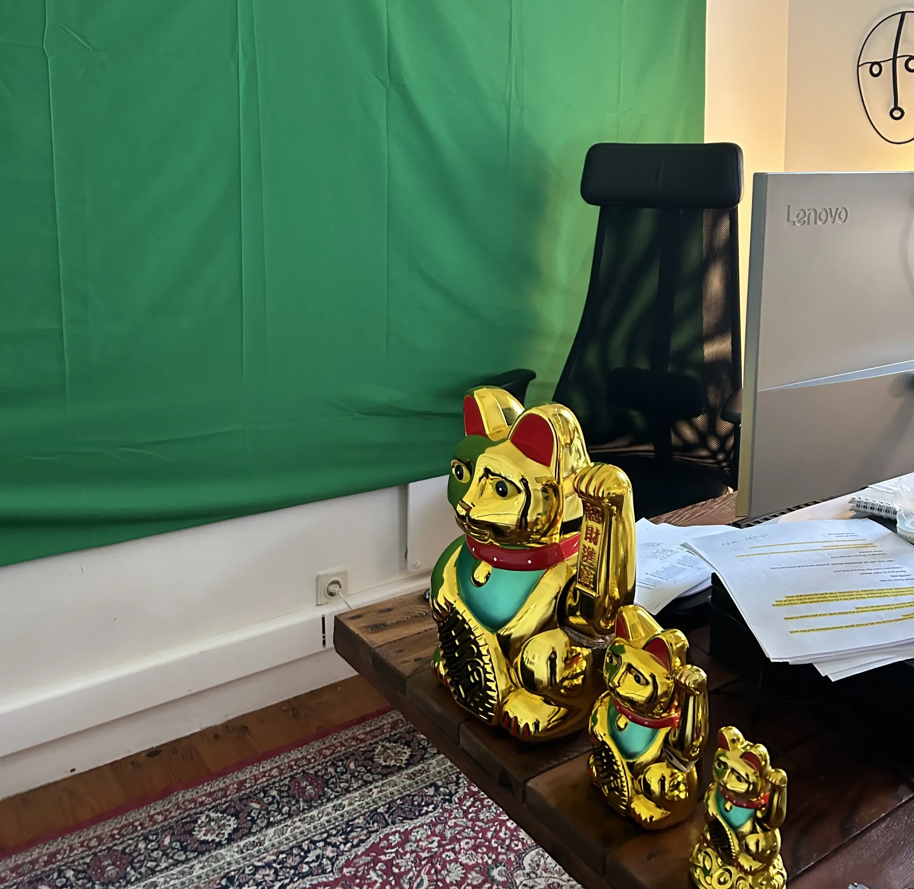 Hackathon set up with a green screen behind a desk